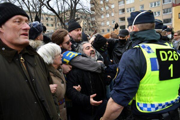 Swedish police break up a demonstration of CCP virus restrictions opponents protesting against a ban on large gatherings, in Stockholm, Sweden, on March 6, 2021. (Henrik Montgomery/TT News Agency via Reuters)