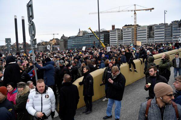 Opponents of CCP virus restrictions stage a protest in defiance of a ban on large gatherings, in Stockholm, Sweden, on March 6, 2021. (Henrik Montgomery/TT News Agency via Reuters)