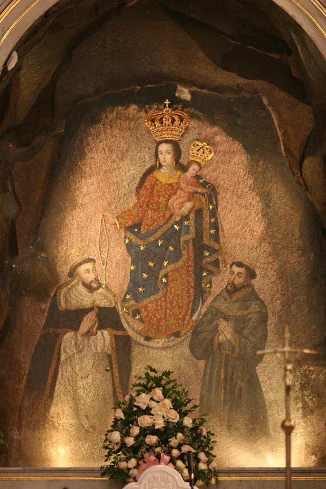 The mysterious mural of the Virgin Mary with Christ (C), St. Dominic (L), and St. Francis is still revered in Las Lajas Shrine today. It’s not known who created the picture, and German geologists who tested the rock discovered that the images are not painted but that the color permeates several feet of the rock itself. (Oscar Garces/Shutterstock.com)