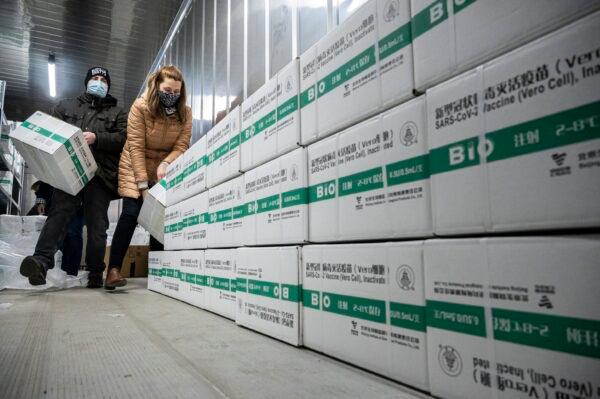 Employees unload the newly arrived CCP virus vaccines from Chinese pharmaceutical company Sinopharm in Budapest, Hungary, on March 3, 2021. (Zsolt Szigetvary/MTI via AP)