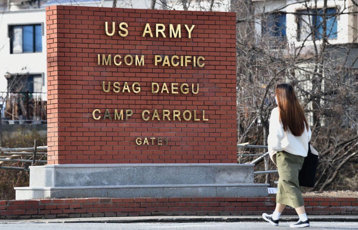 A woman walks past the main gate of U.S. Army Camp Carroll in Chilgok, South Korea, on Feb. 26, 2020. (Jung Yeon-je/AFP via Getty Images)