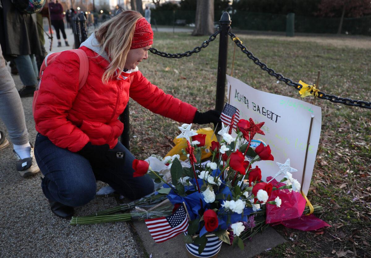 Melody Black, from Minnesota, becomes emotional as she visits a memorial setup near the U.S. Capitol Building for Ashli Babbitt who was killed in the building the day prior, in Washington, on Jan. 7, 2021. (Joe Raedle/Getty Images)