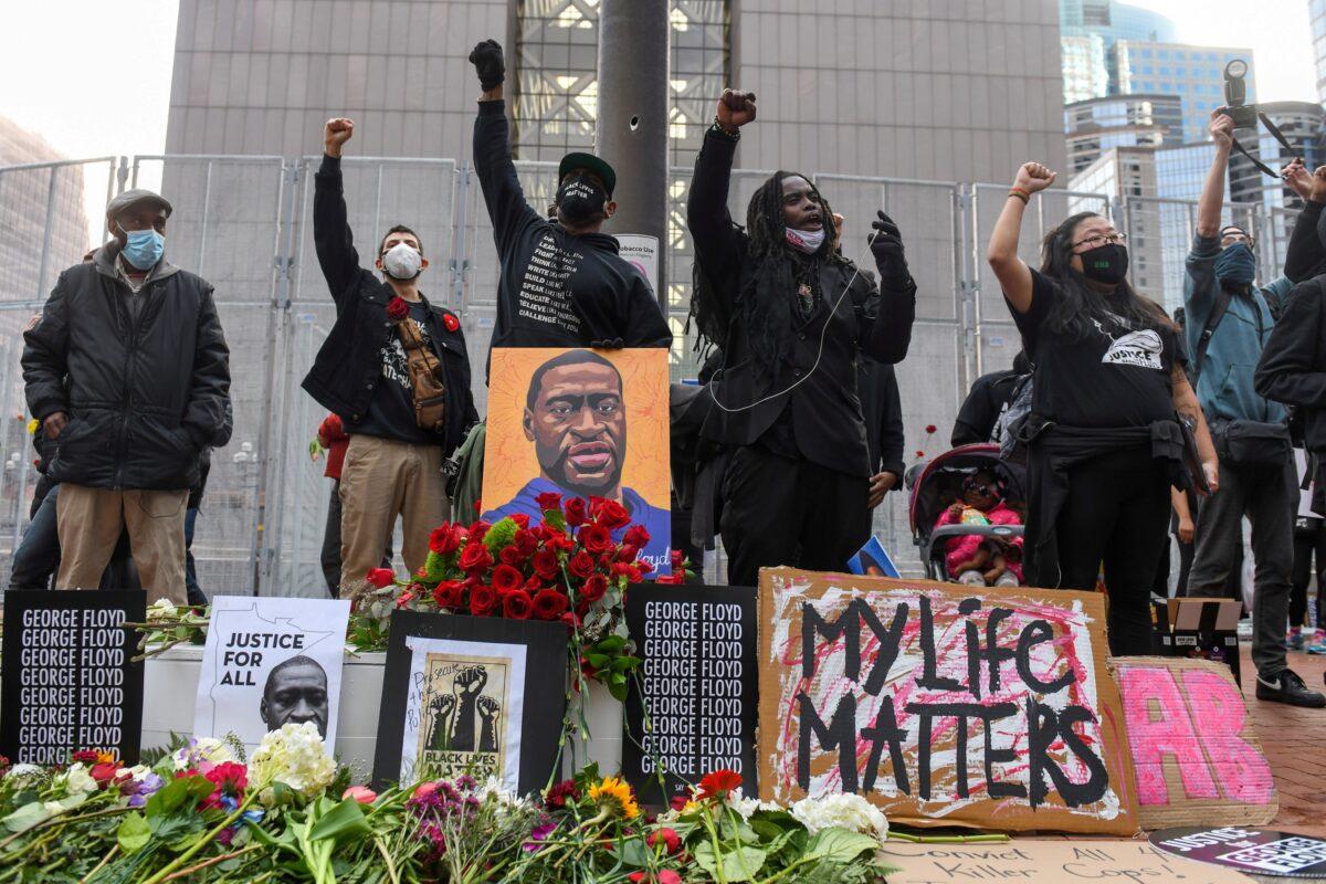 Protesters raise their fists and chant after a march a day before jury selection is scheduled to begin for the trial of Derek Chauvin, the former Minneapolis policeman accused of killing George Floyd, in Minneapolis, Minn., on March 7, 2021. (Nicholas Pfosi/Reuters)
