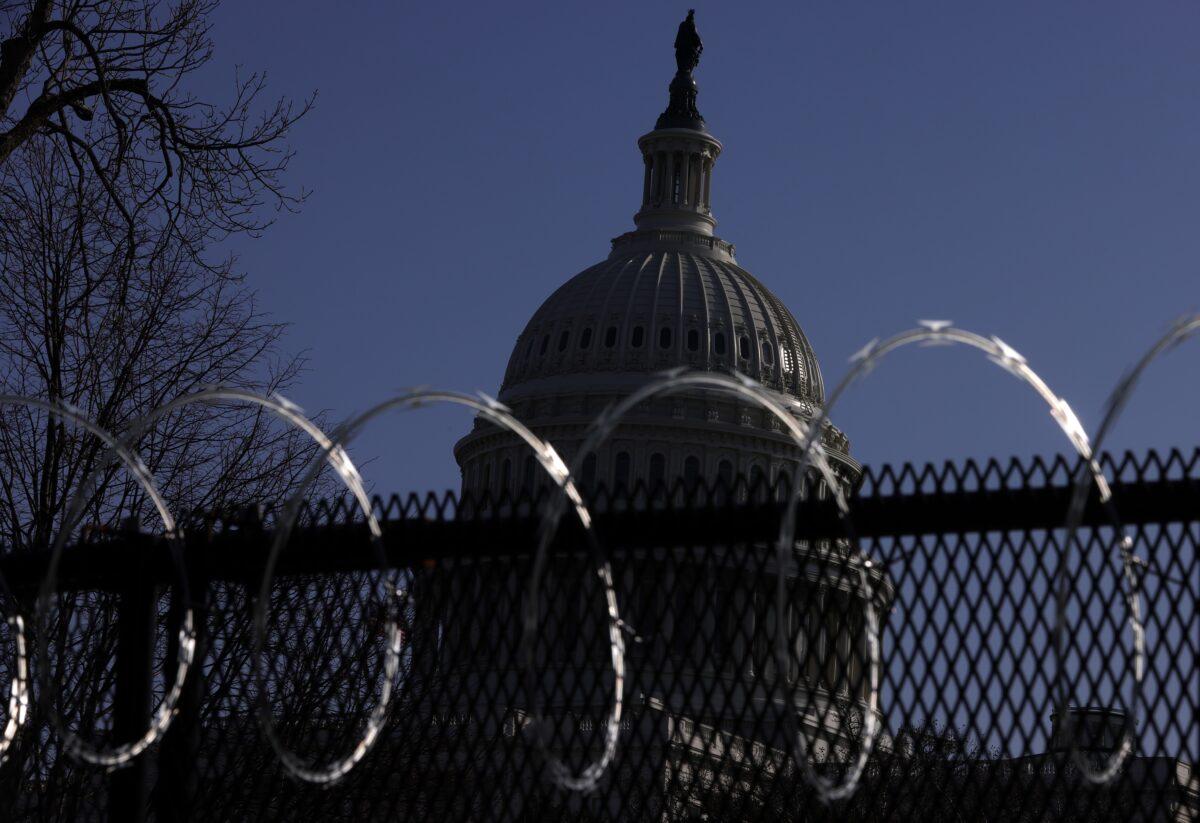 Razor wire is attached to the top of temporary fencing as the U.S. Capitol is seen in the background, in Washington on March 4, 2021. (Alex Wong/Getty Images)