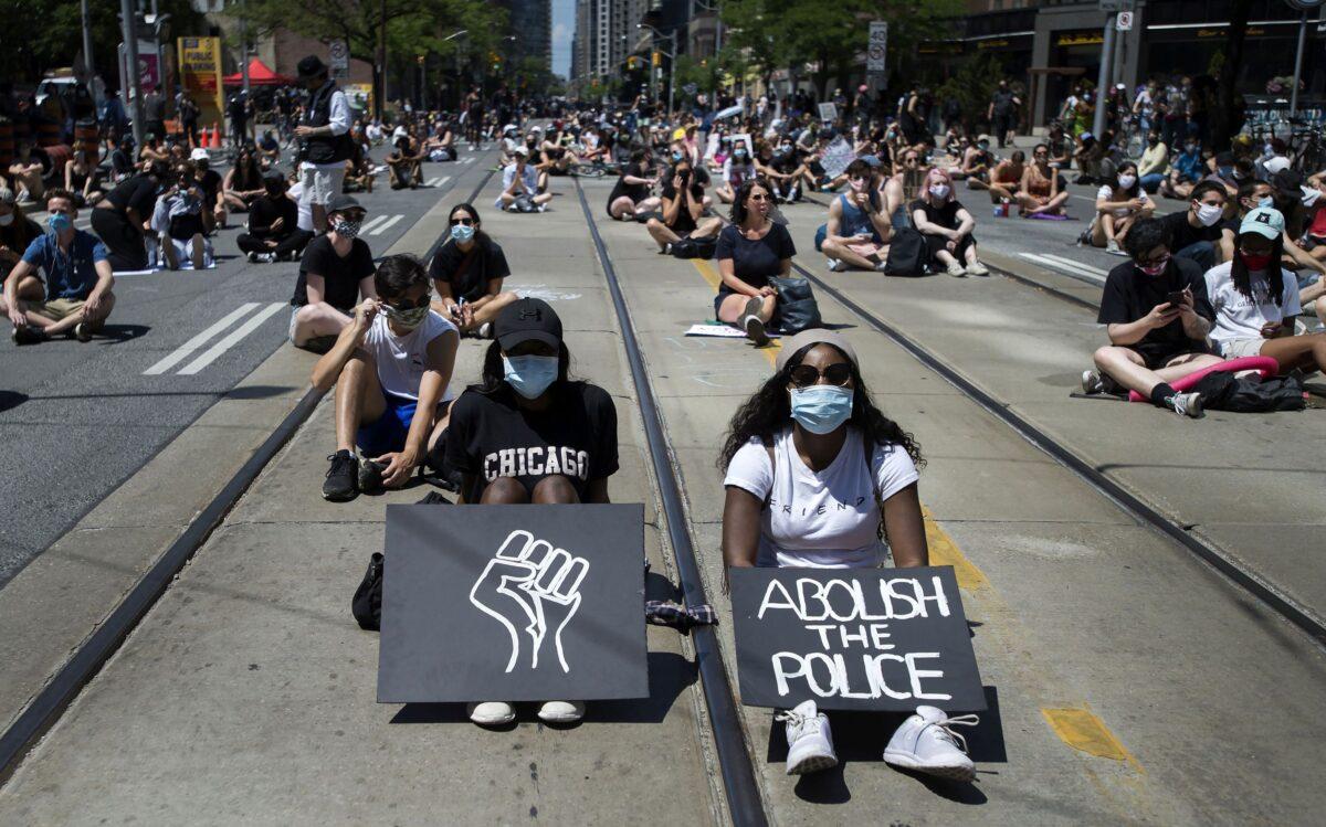 Thousands of people take part in a demonstration to defund the police in support of Black Lives Matter in Toronto, on June 19, 2020. (The Canadian Press/Nathan Denette)
