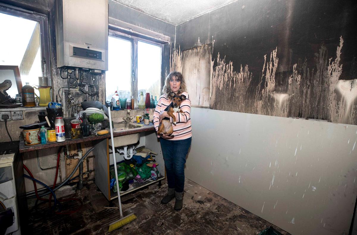 Diane with her dog Bella in her burned-out house (Caters News)