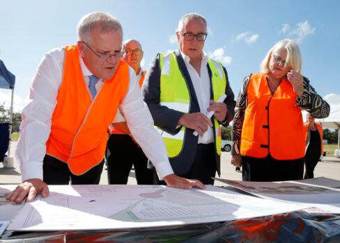 Prime Minister Scott Morrison inspects plans with Mark Chilcott of Energy Renaissance, and Industry Minister Karen Andrews during a recent visit to their site in Tomago, NSW, on March 4, 2021. (AAP Image/Darren Pateman)