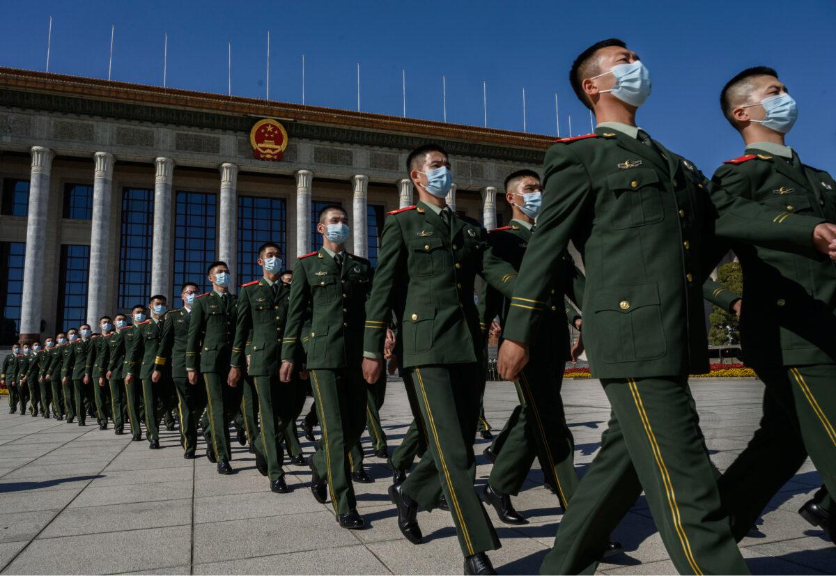 Chinese soldiers from the People's Liberation Army wear masks as they march after a ceremony marking the 70th anniversary of China's entry into the Korean War, at the Great Hall of the People in Beijing, China, on Oct. 23, 2020. (Kevin Frayer/Getty Images)