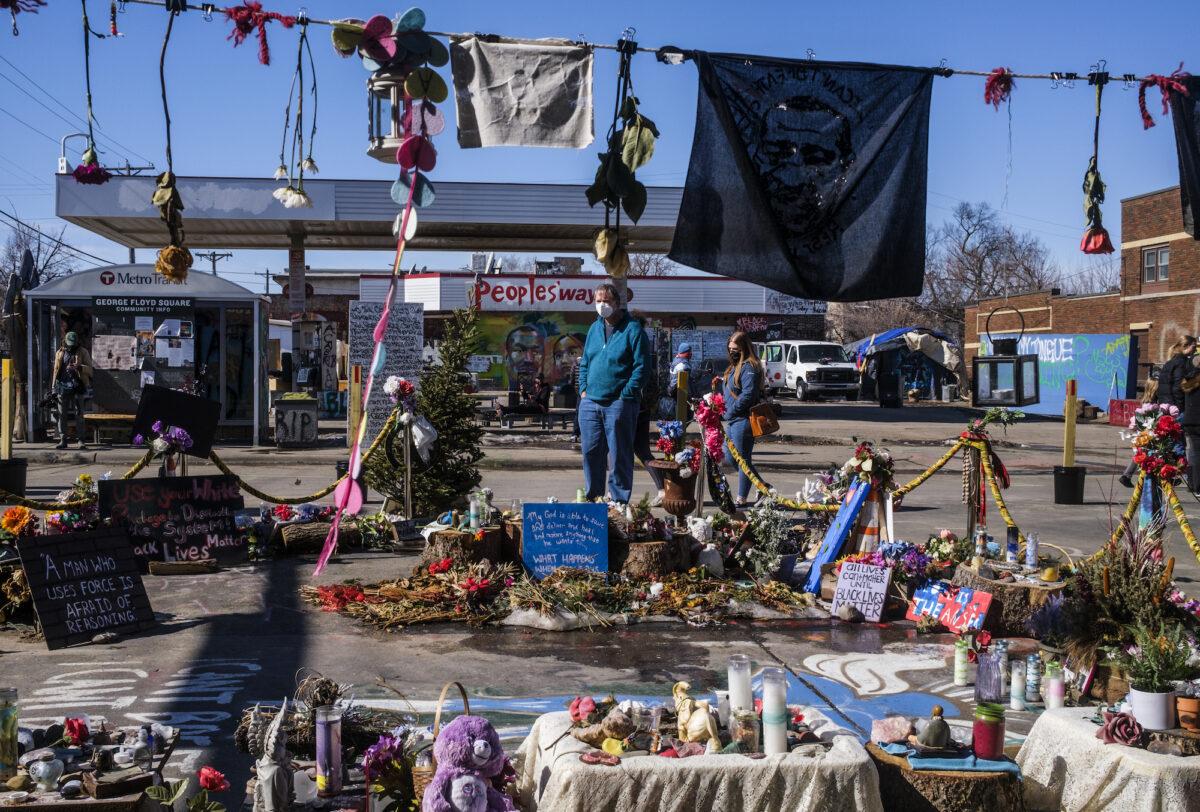 People visit George Floyd Square, the memorial created around the site where he died last May, in Minneapolis, on March 6, 2021. (Stephen Maturen/Getty Images)