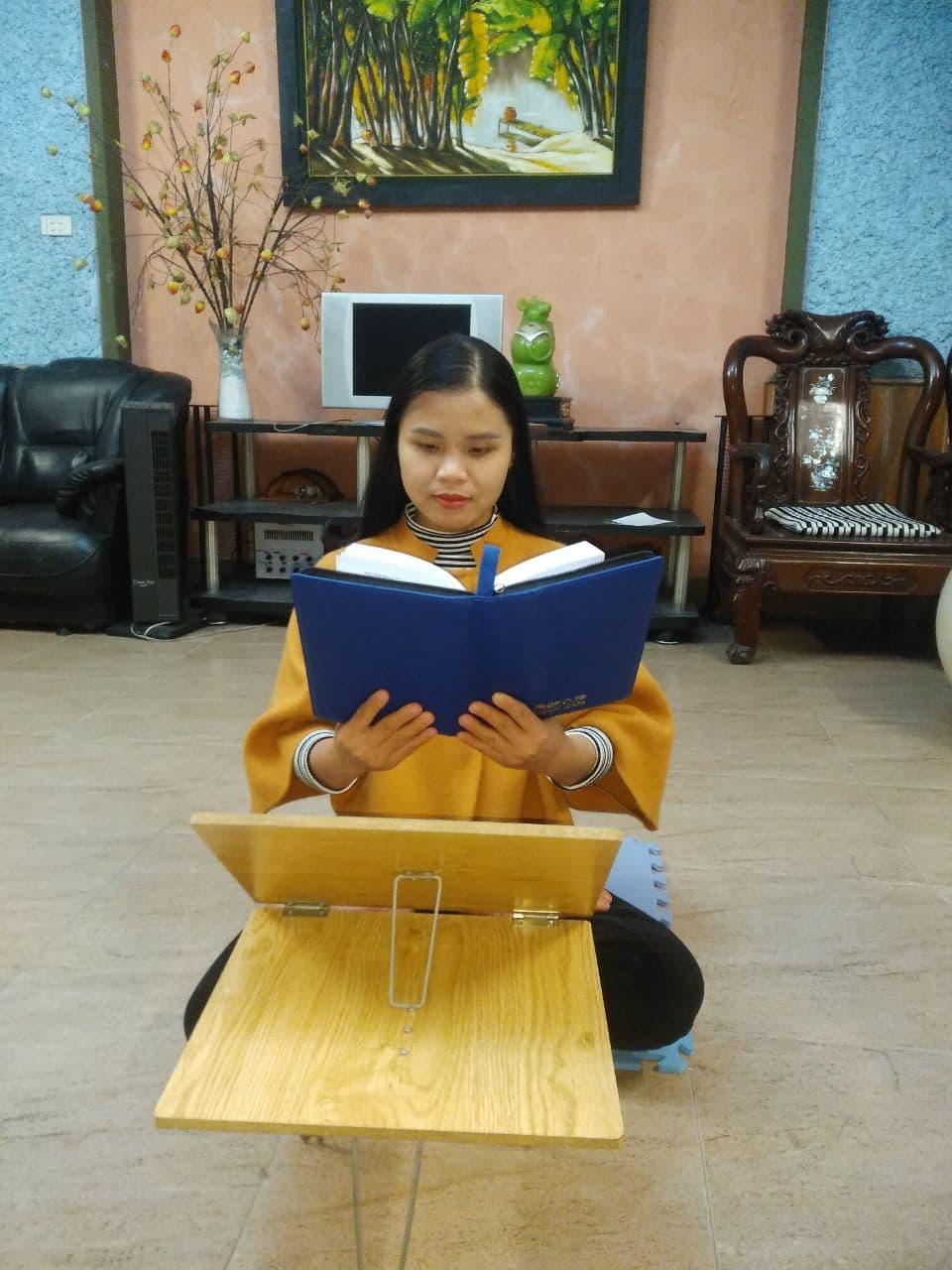 Hien reads Zhuan Falun, the main spiritual book of Falun Gong. (Courtesy of Thu Hien Ta)