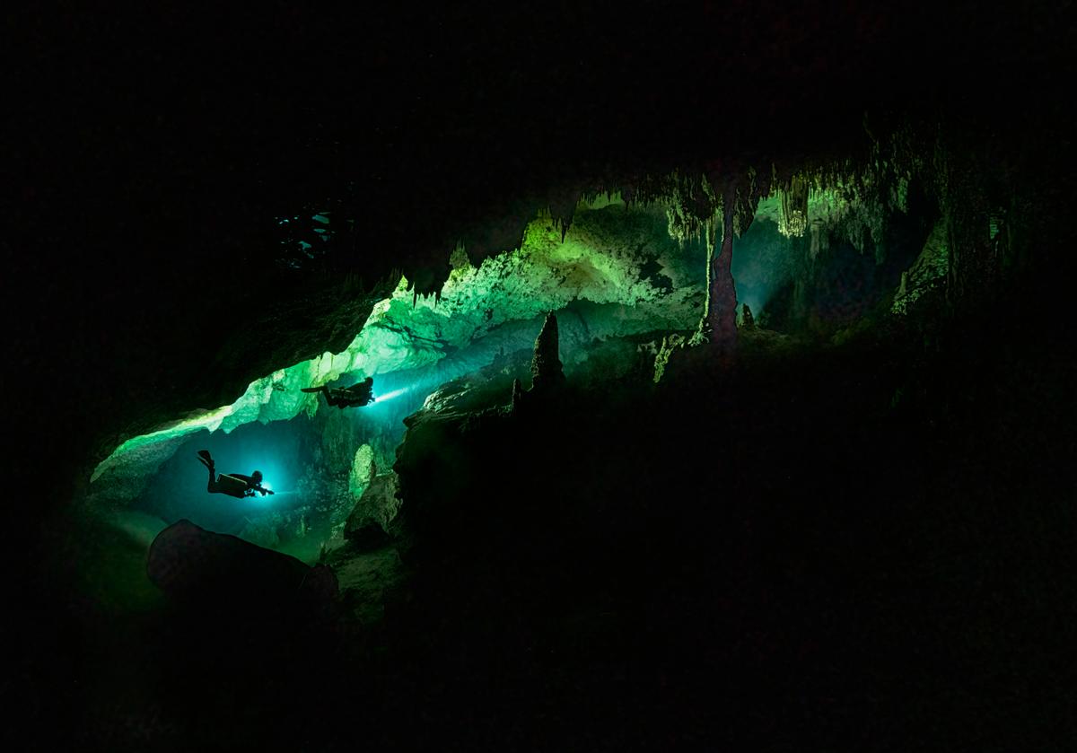 These eerie yet magical photographs show part of a worshipped Mayan world—a glimpse into the world's longest underwater cave systems. (Caters News)