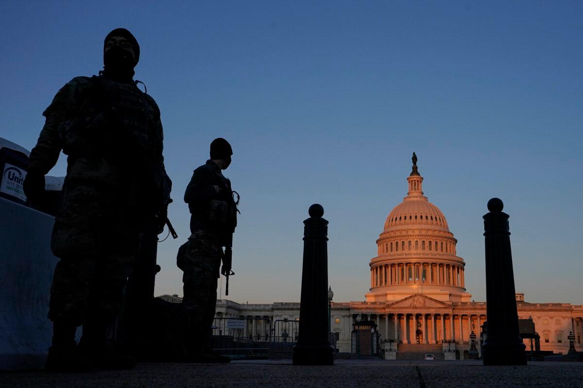 National Guard stand their posts around the Capitol at sunrise in Washington on March 8, 2021. (Carolyn Kaster/AP Photo)