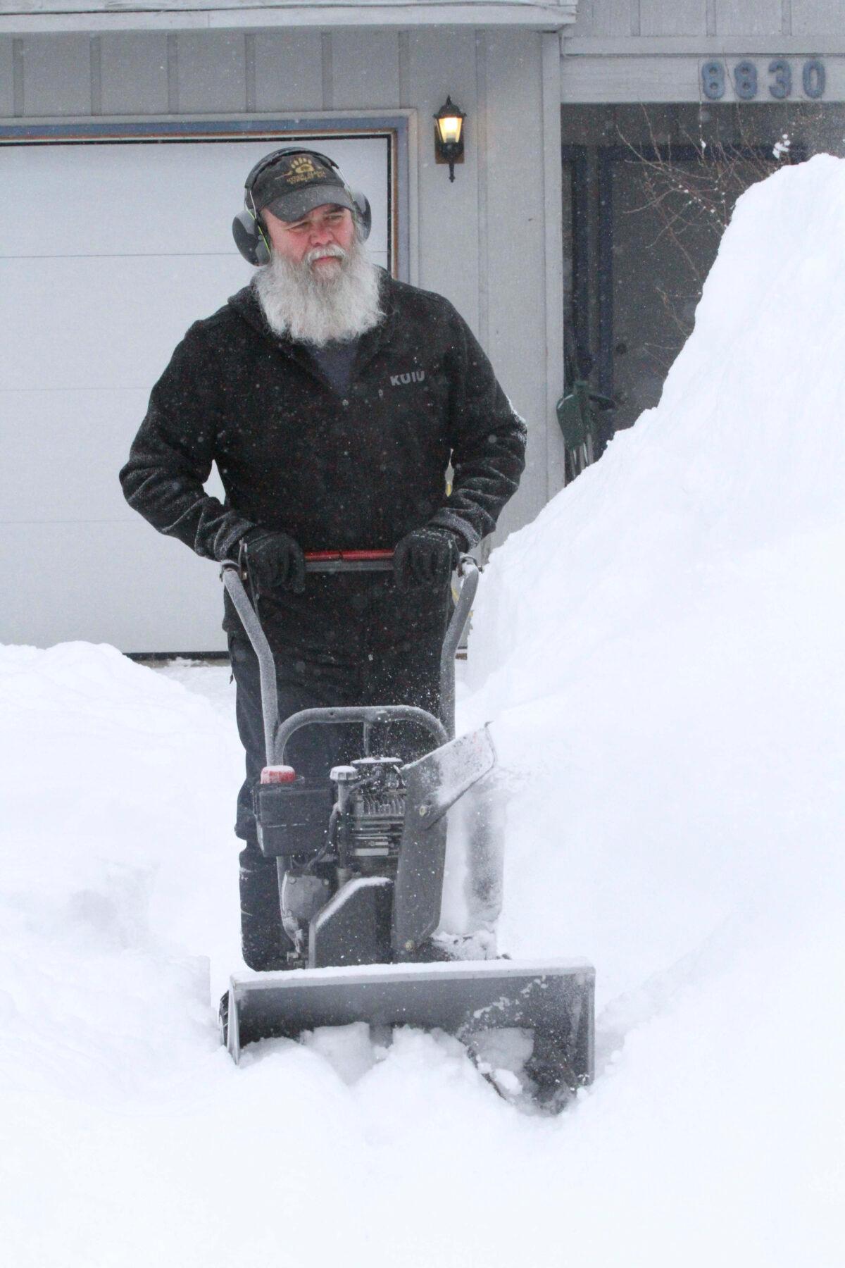 Dirk Westfall operates a snowblower at his home in Anchorage, Alaska, on March 11, 2021. (Mark Thiessen/AP Photo)