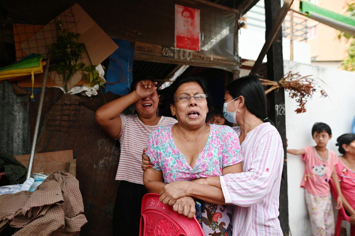 Family members of Aung Than, 41, who was killed during a raid by security forces cry at their home in Thaketa, Yangon, Burma March 13, 2021. (Stringer/Reuters)