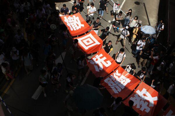 Demonstrators display a banner reading "withdraw brainwashing education" during a protest against the government's efforts to implement national education in Hong Kong on July 29, 2012. (Dale de la Rey/AFP/GettyImages)