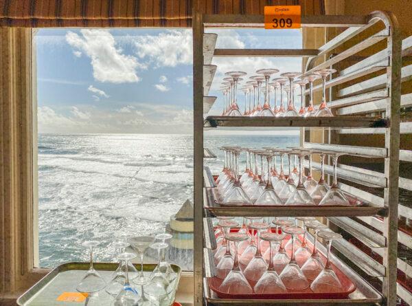 Glassware is stacked neatly for auction at the Cliff House in San Francisco on March 10, 2021. (Ilene Eng/The Epoch Times)