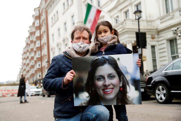 Richard Ratcliffe, husband of British-Iranian aid worker Nazanin Zaghari-Ratcliffe, and their daughter Gabriella protest outside the Iranian Embassy in London, Britain, on March 8, 2021. (Andrew Boyers/Reuters)