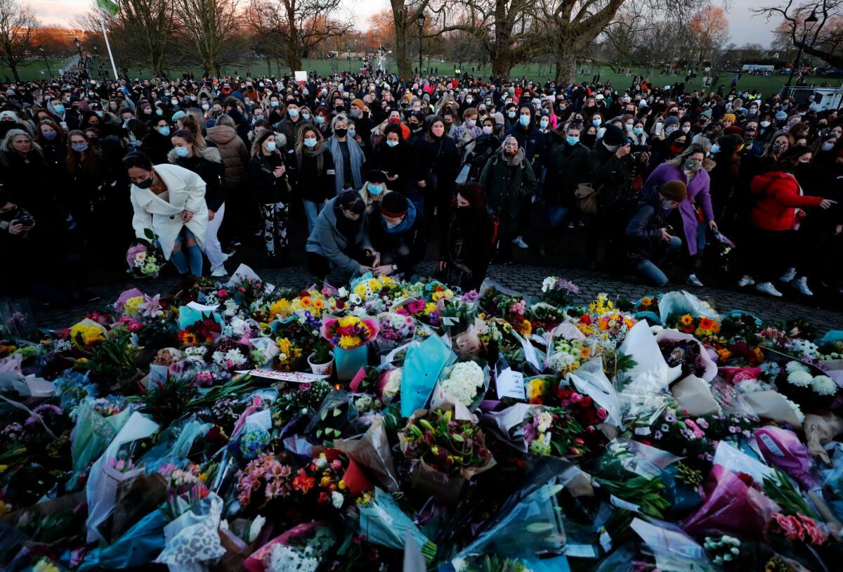 People gather, at the band stand in Clapham Common, in memory of Sarah Everard, after an official vigil was cancelled, in London, on March 13, 2021. (Frank Augstein/AP Photo)