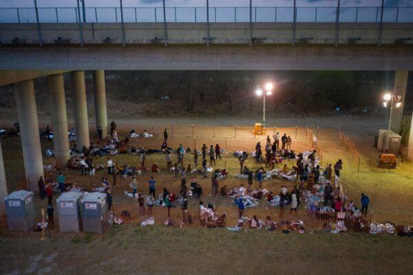 Illegal immigrants from Central America take refuge in a makeshift U.S. Customs and Border Protection processing center under the Anzalduas International Bridge after crossing the Rio Grande river into the United States from Mexico in Granjeno, Texas, on March 12, 2021. (Adrees Latif/Reuters)