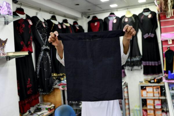 A salesman shows a full face veil, niqab, at a shop selling various kinds of coverings worn by Muslim women in Colombo, Sri Lanka, on April 29, 2019. (Danish Siddiqui/Reuters)