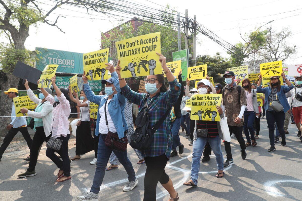 Anti-coup protesters display placards and shout slogans as they protest against the military coup in Mandalay, Burma, on March 15, 2021. (AP Photo)