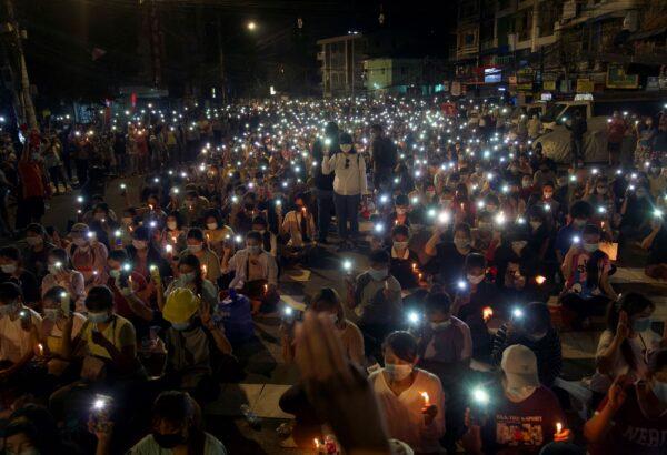 Anti-coup protesters turn on the LED light of their mobile phones during a candlelight night rally in Yangon, Burma, on March 14, 2021. (AP Photo)