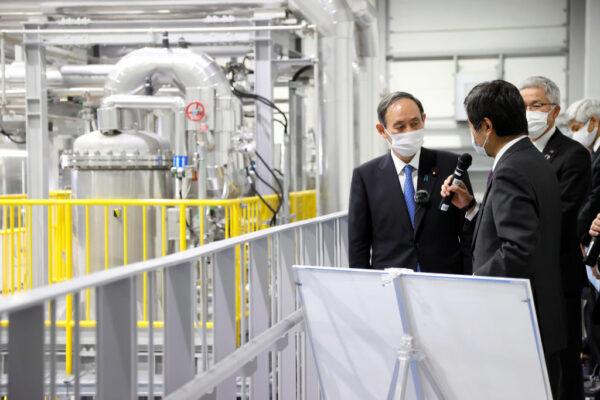 Japan's Prime Minister Yoshihide Suga visits a hydrogen production facility in Namie, Fukushima Prefecture on March 6, 2021. (STR/Japan Pool /AFP via Getty Images)