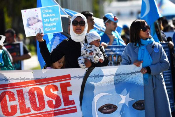 Protestors attend a rally for the Uyghur community at Parliament House on March 15, 2021 in Canberra, Australia. (Photo by Sam Mooy/Getty Images)