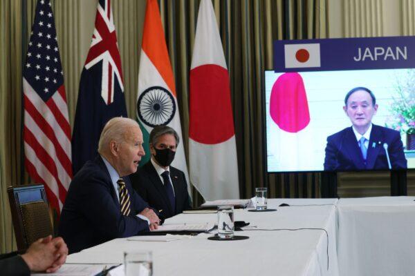 President Joe Biden, Secretary of State Anthony Blinken, and Japanese Prime Minister Yoshihide Suga (on screen) participate in a virtual meeting with leaders of Quadrilateral Security Dialogue countries at the State Dining Room of the White House in Washington, on March 12, 2021. (Alex Wong/Getty Images)