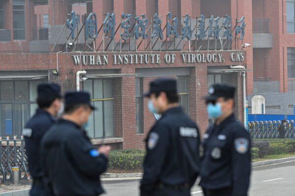Security personnel stand guard outside the Wuhan Institute of Virology in Wuhan as members of the World Health Organization (WHO) team investigating the origins of COVID-19 make a visit to the institute in Wuhan, China, on Feb. 3, 2021. (Hector Retamal /AFP via Getty Images)