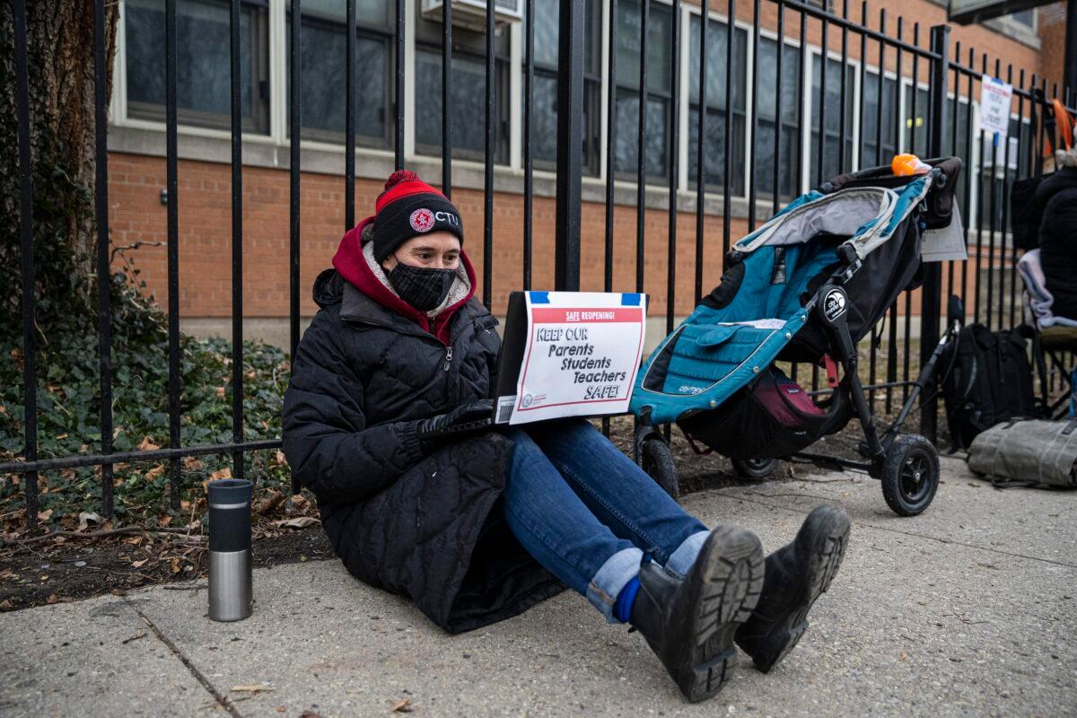 A Suder Montessori Magnet Elementary School teacher speaks to students during a virtual class outside of the school in solidarity with pre-K educators forced back into the building in Chicago, on Jan. 11, 2021. (Anthony Vazquez/Chicago Sun-Times via AP