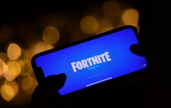 This illustration picture shows a person logging into Epic Games' Fortnite on their smartphone in Los Angeles on Aug. 14, 2020. (Chris Delmas/AFP via Getty Images)