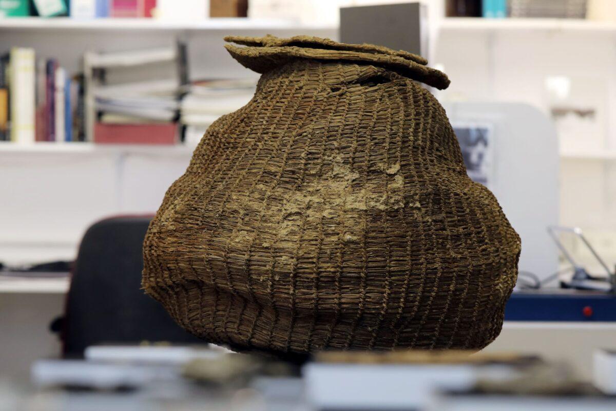 An ancient complete basket, part of various artifacts recently discovered in the Judean Desert caves, is seen during an unveiling event for media at Israel Antiquities Authority laboratories in Jerusalem, Israel, on March 16, 2021. (Ammar Awad/Reuters)