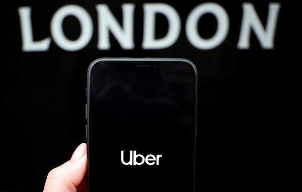 The Uber logo is displayed on a mobile phone in this picture illustration taken on Nov. 25, 2019. (Hannah McKay/Illustration/ Reuters)