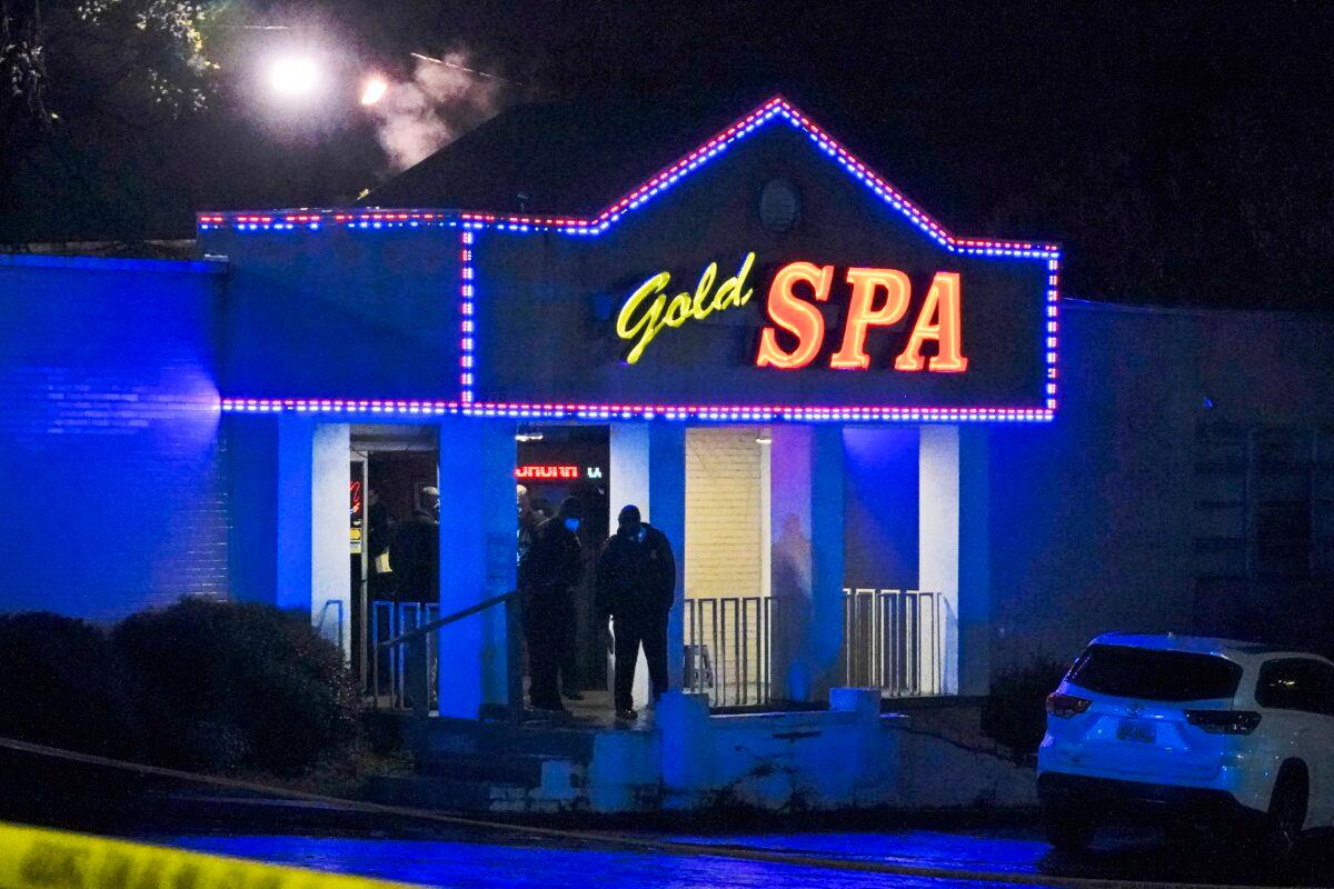 Officials stand in front of a massage parlor after a shooting, in Atlanta, Ga., on March 16, 2021. (Brynn Anderson/AP Photo)