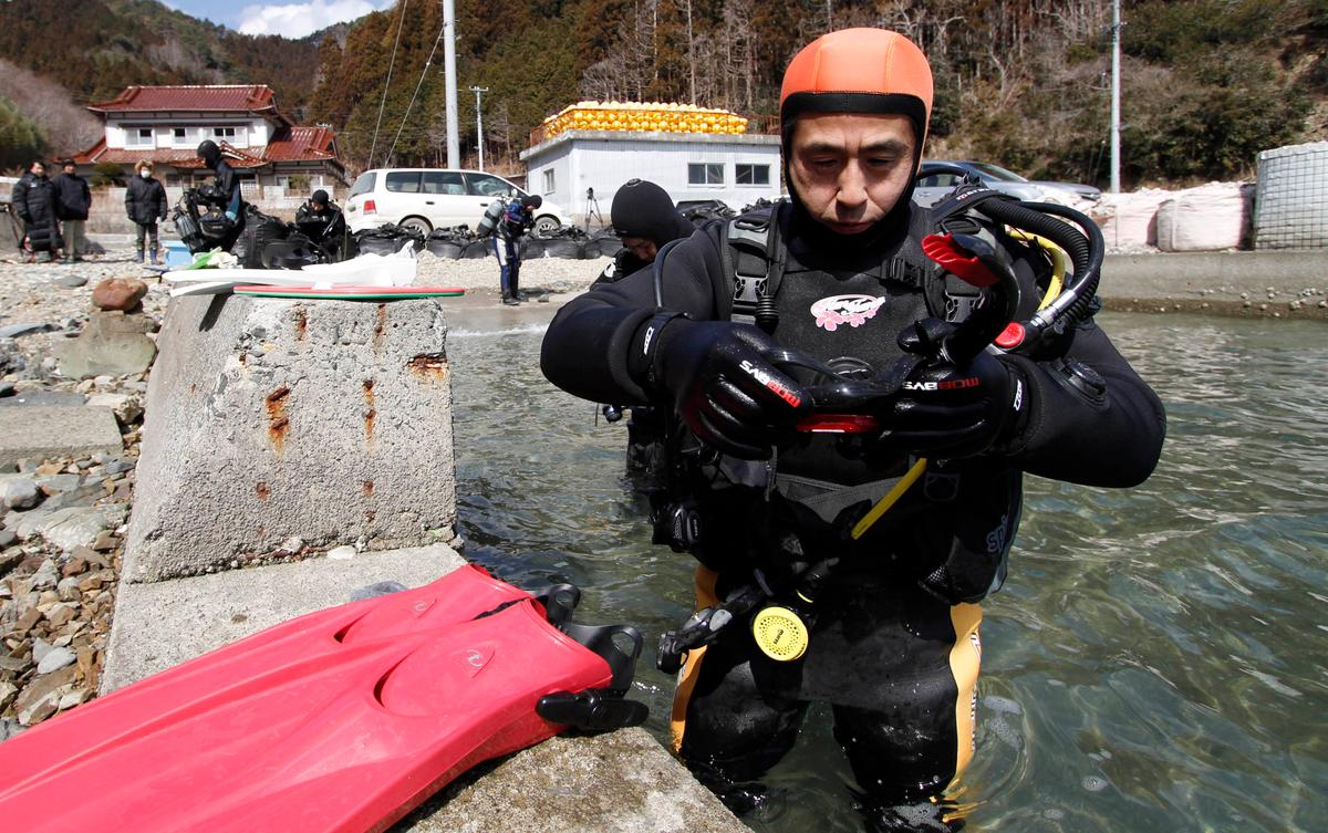 Yasuo Takamatsu prepares to take a diving lesson at Takenoura bay, Miyagi prefecture, northern Japan. (Koji Ueda/AP)