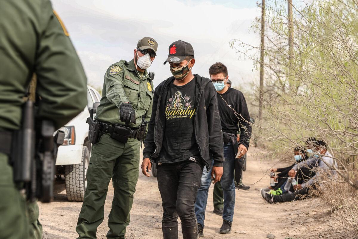 Border Patrol agents arrest seven illegal immigrants who tried to evade capture near Penitas, Texas, on March 15, 2021. (Charlotte Cuthbertson/The Epoch Times)