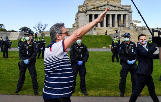 A protester performs a Nazi salute at the Shrine of Remembrance in Melbourne on September 5, 2020 during an anti-lockdown rally (William West/AFP via Getty Images)