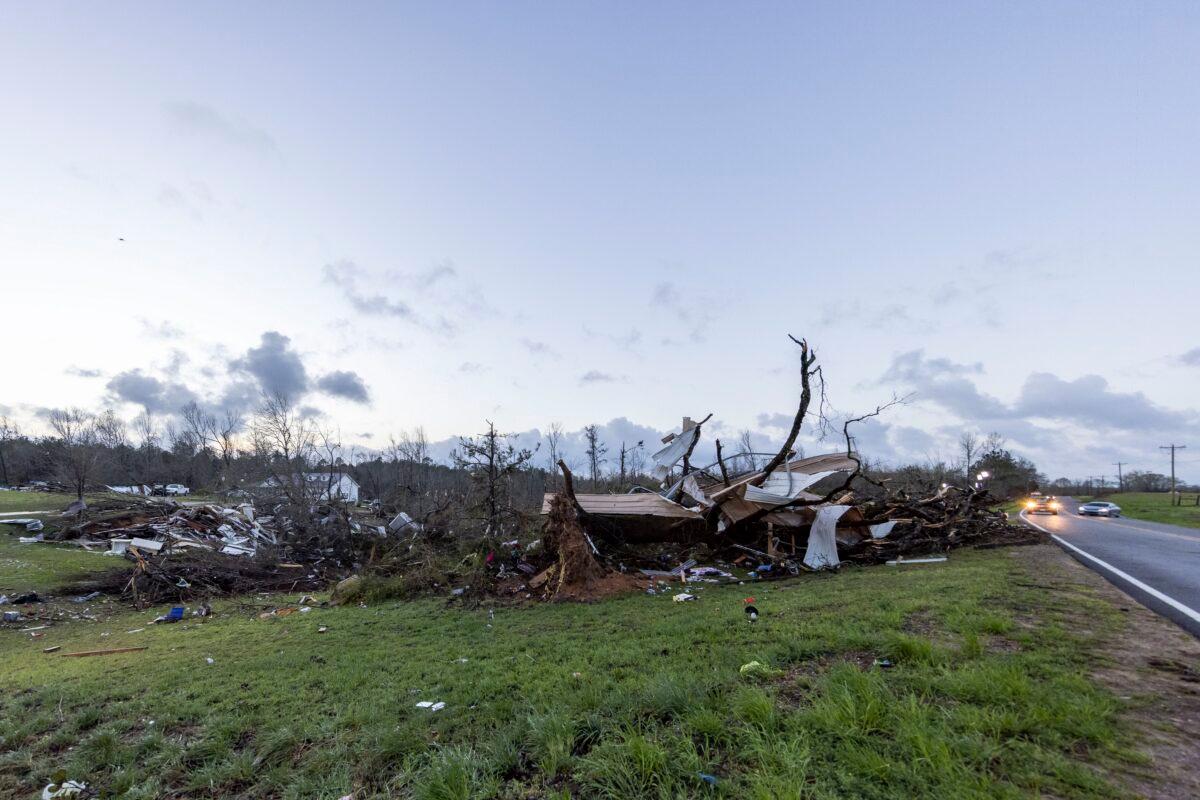 The sun rises over weather-damaged properties at the intersection of County Road 24 and 37 in Clanton, Ala., the morning following a large outbreak of severe storms across the southeast, on March 18, 2021. (Vasha Hunt/AP Photo)