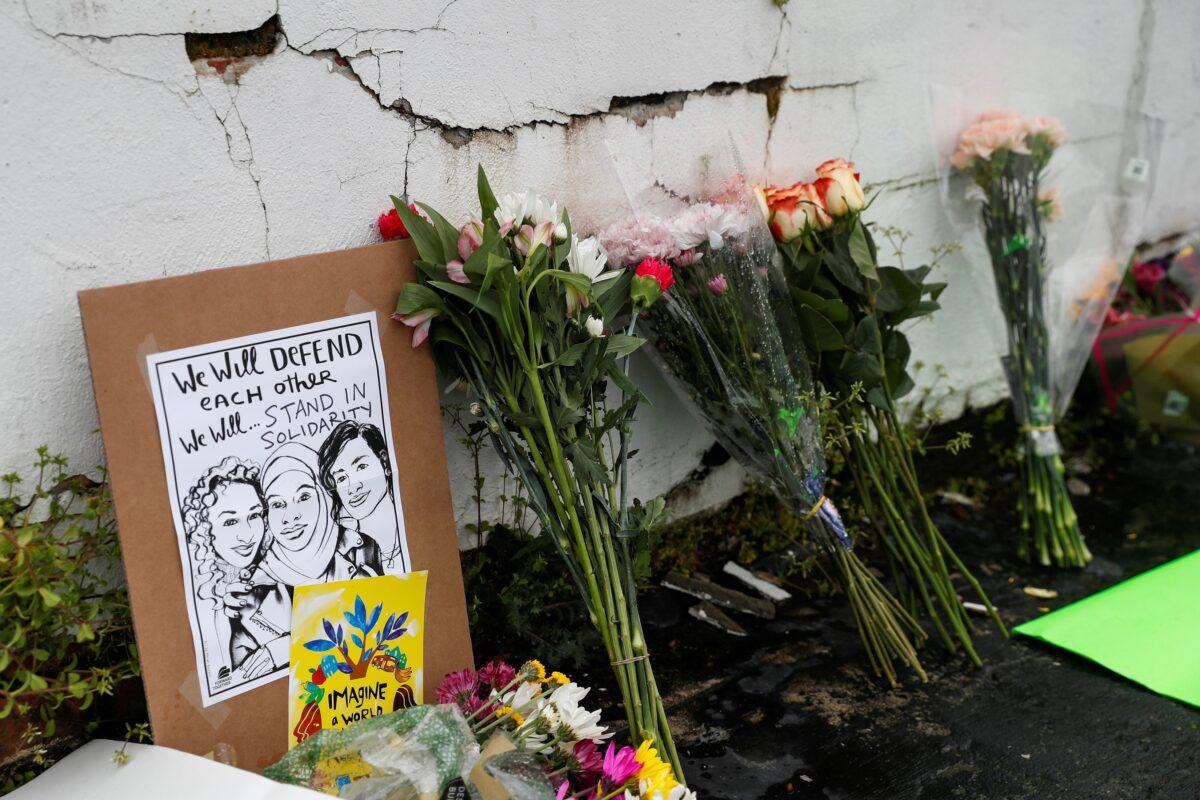 Flowers and a poster are left outside Gold Spa following the deadly shootings in Atlanta, Ga., on March 17, 2021. (Shannon Stapleton/Reuters)