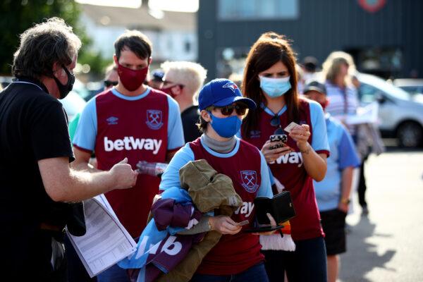 West Ham fans queue to enter the stadium prior to the Barclays FA Women's Super League match between West Ham United and Arsenal at Chigwell Construction Stadium in Dagenham, England, on Sept. 12, 2020. (Marc Atkins/Getty Images)