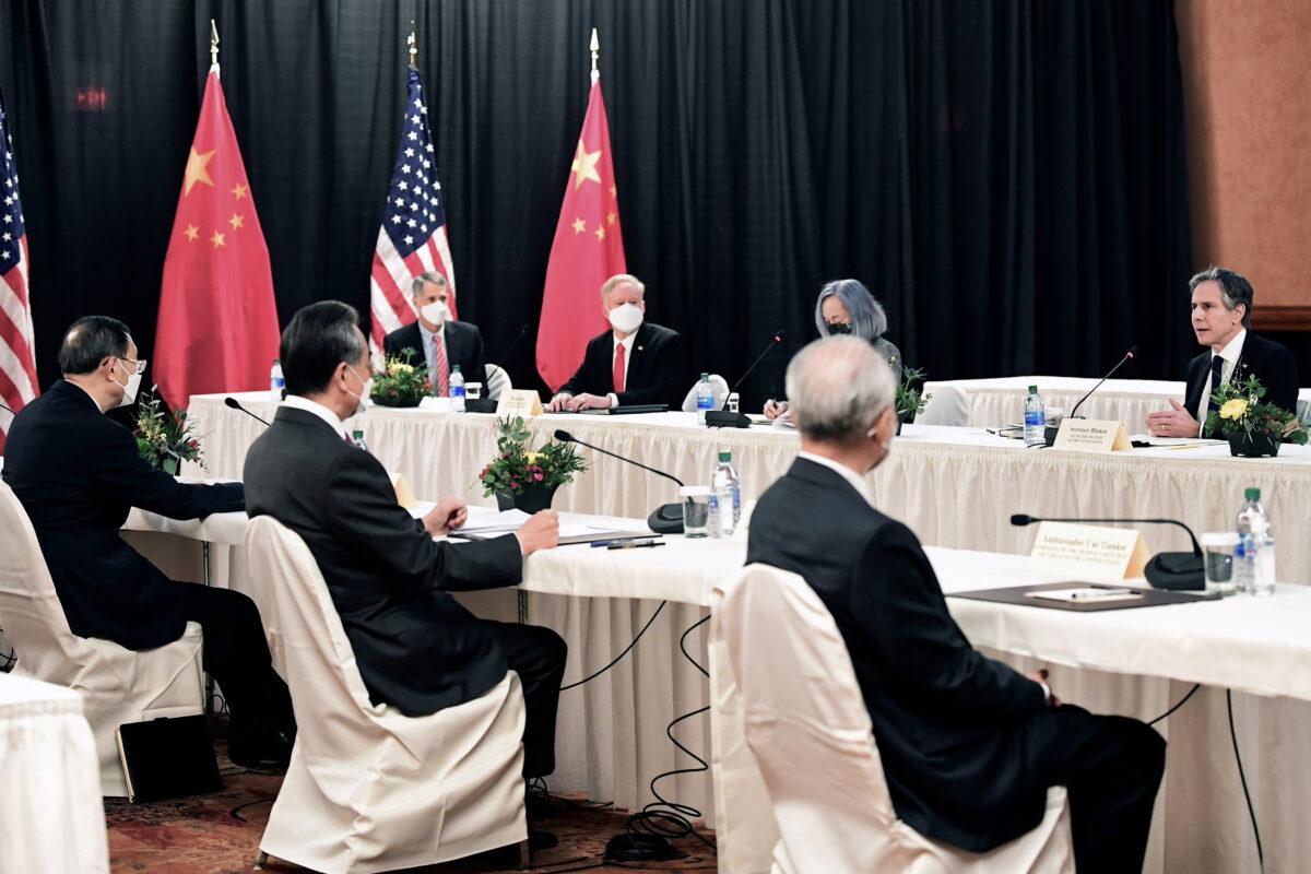 U.S. Secretary of State Antony Blinken (R) speaks while facing Yang Jiechi (L), director of the Central Foreign Affairs Commission Office, and Wang Yi (2nd L), China's State Councilor Wang and Foreign Minister, at the opening session of U.S.-China talks at the Captain Cook Hotel in Anchorage, Alaska, on March 18, 2021. (Frederic J. Brown/Pool via Reuters)