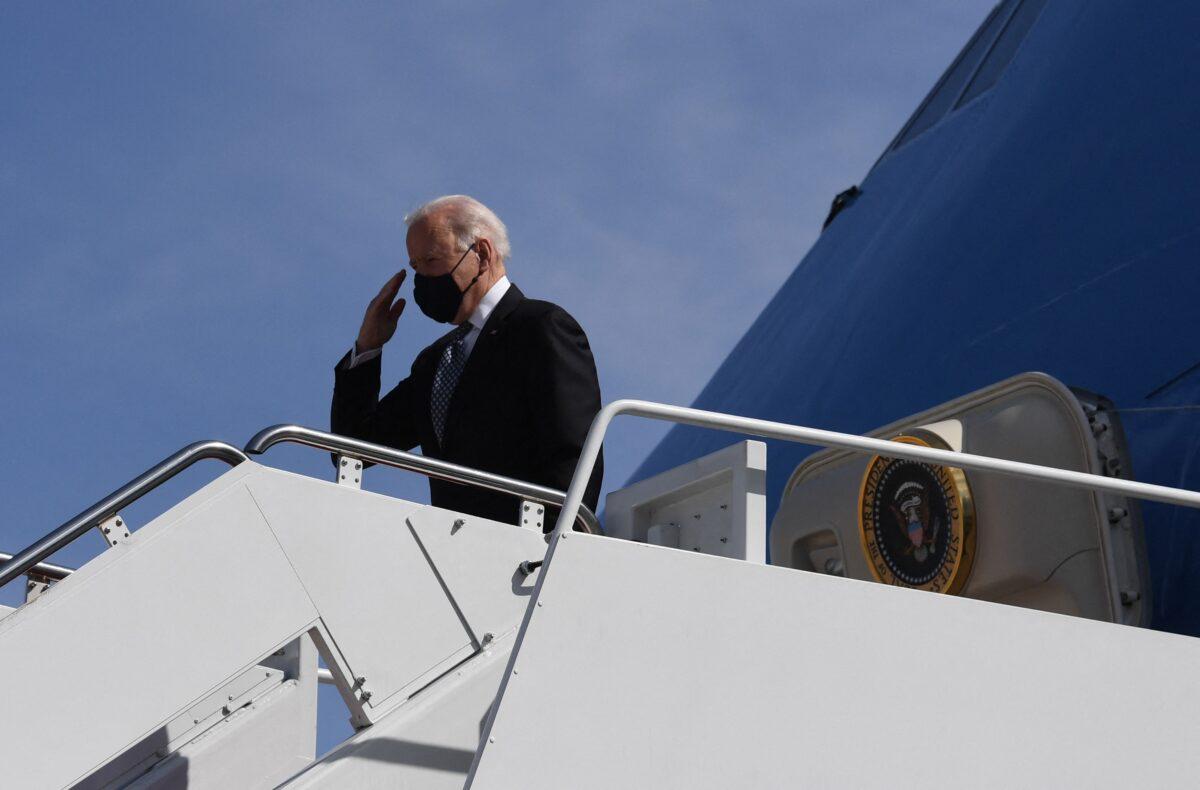 President Joe Biden salutes as he boards Air Force One at Joint Base Andrews in Maryland on March 19, 2021. (Eric Baradat/AFP via Getty Images)