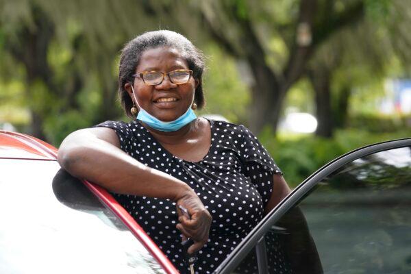 Doramise Moreau stands next to the new car she received for her community service at Notre Dame d'Haiti Catholic Church in Miami, Fla., on March 8, 2021. (Marta Lavandier/ AP Photo)