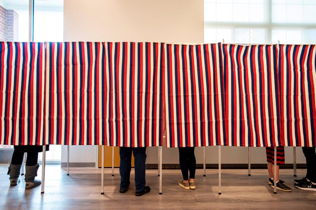 Voters fill in their ballots at polling booths in Concord, N.H., on Nov. 3, 2020. (Joseph Prezioso/AFP via Getty Images)