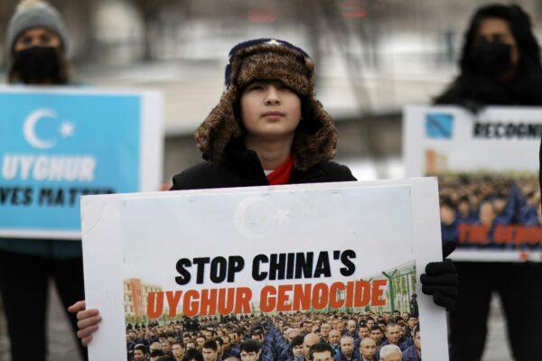 People take part in a rally to encourage Canada and other countries as they consider labeling China's treatment of its Uyghur population and Muslim minorities as genocide, outside the Canadian Embassy in Washington on Feb. 19, 2021. (Leah Millis/Reuters)