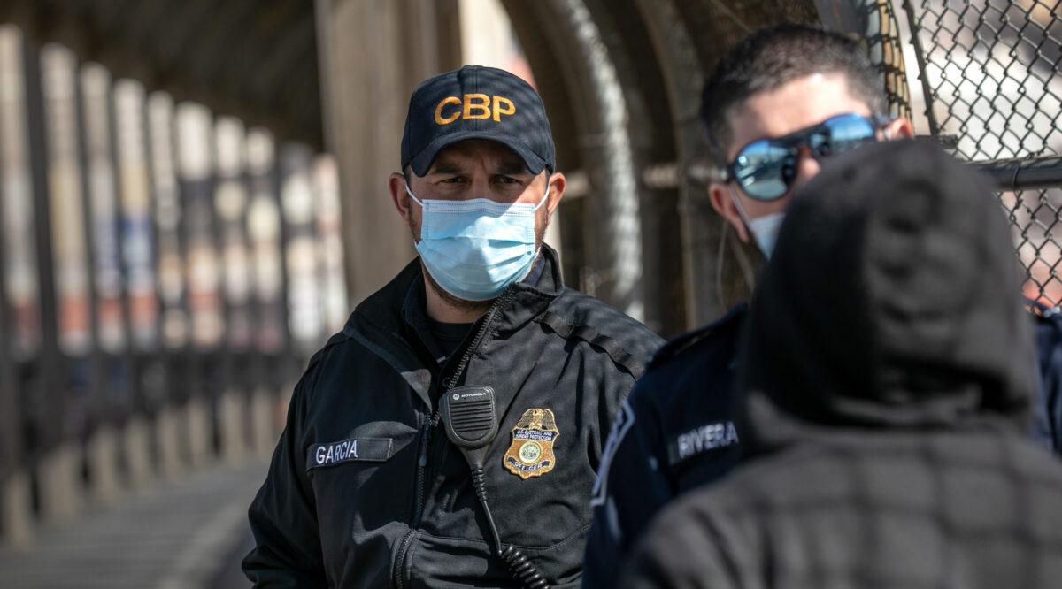 U.S. Customs and Border Protection officers turn back an illegal immigrant trying to cross into the United States from Ciudad Juarez, Mexico, on March 16, 2021. (John Moore/Getty Images)