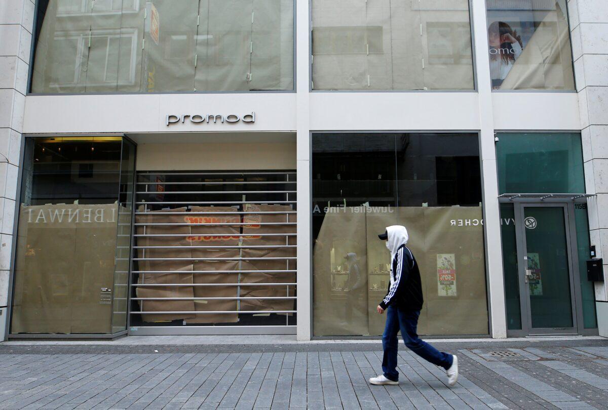 A man walks along a closed shop at the main shopping street Hohe Strasse amid the coronavirus disease (COVID-19) pandemic in Cologne, Germany, on March 18, 2021. (Thilo Schmuelgen/Reuters)