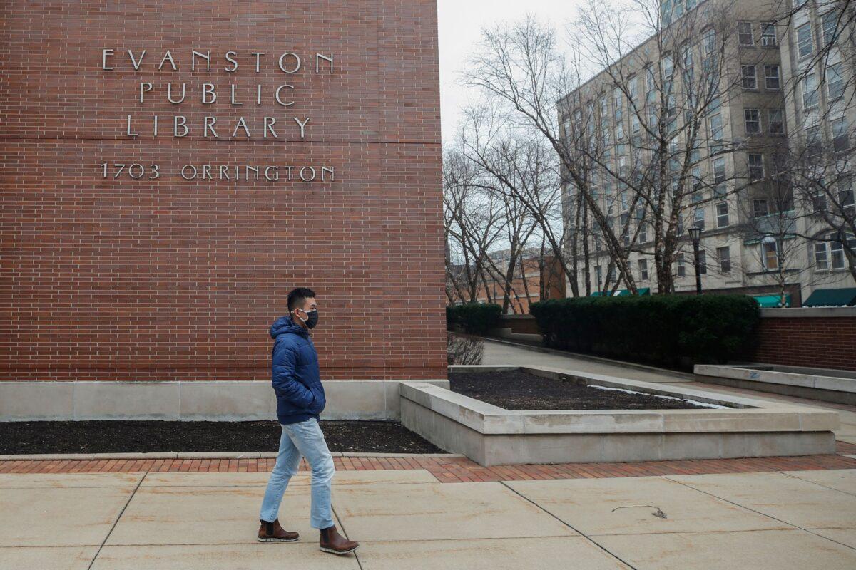 A man walks past the Evanston Public Library in Evanston, Ill., on March 16, 2021. (Kamil Krzaczynski/AFP/Getty Images)