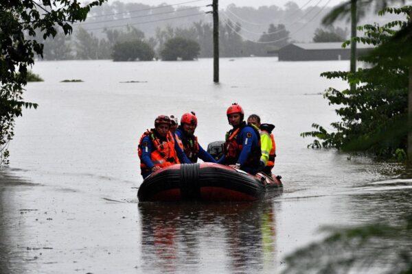 State Emergency Service volunteers patrol a flooded residential area in Richmond, NSW on March 22, 2021. (Saeed Khan/AFP via Getty Images)
